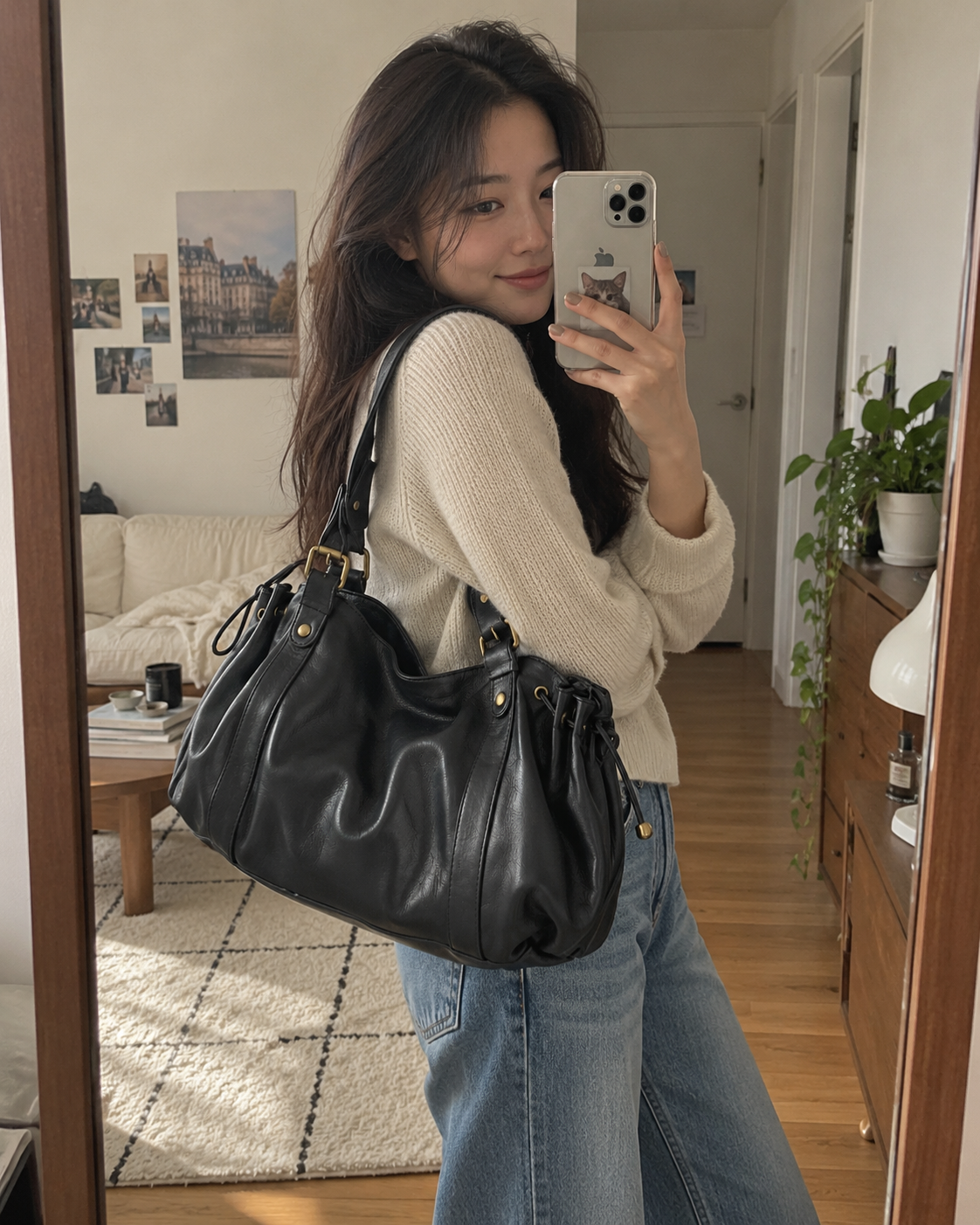 The Valen Hobo in Classic Black worn with a cream sweater for a mirror styling portrait.