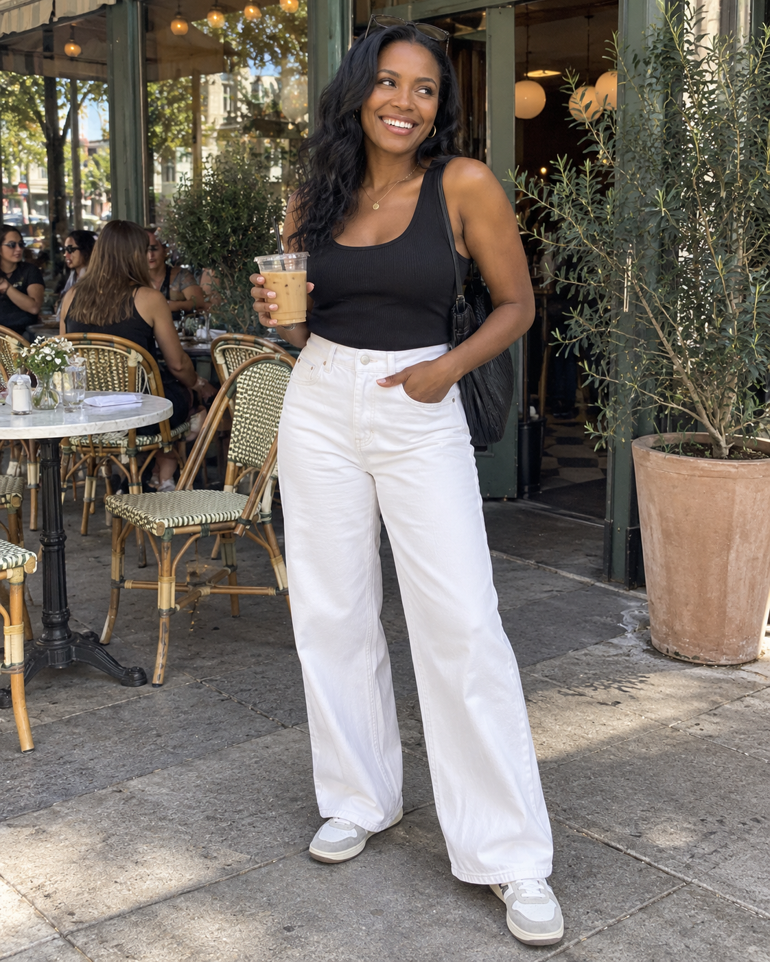 The Valen Wide-Leg Jean in White styled with a black sleeveless top outdoors